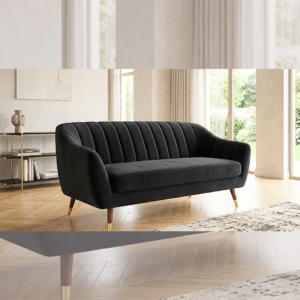 Sleek modern black channel-tufted velvet sofa with tapered legs and gold accents, displayed in a bright, minimalist home interior